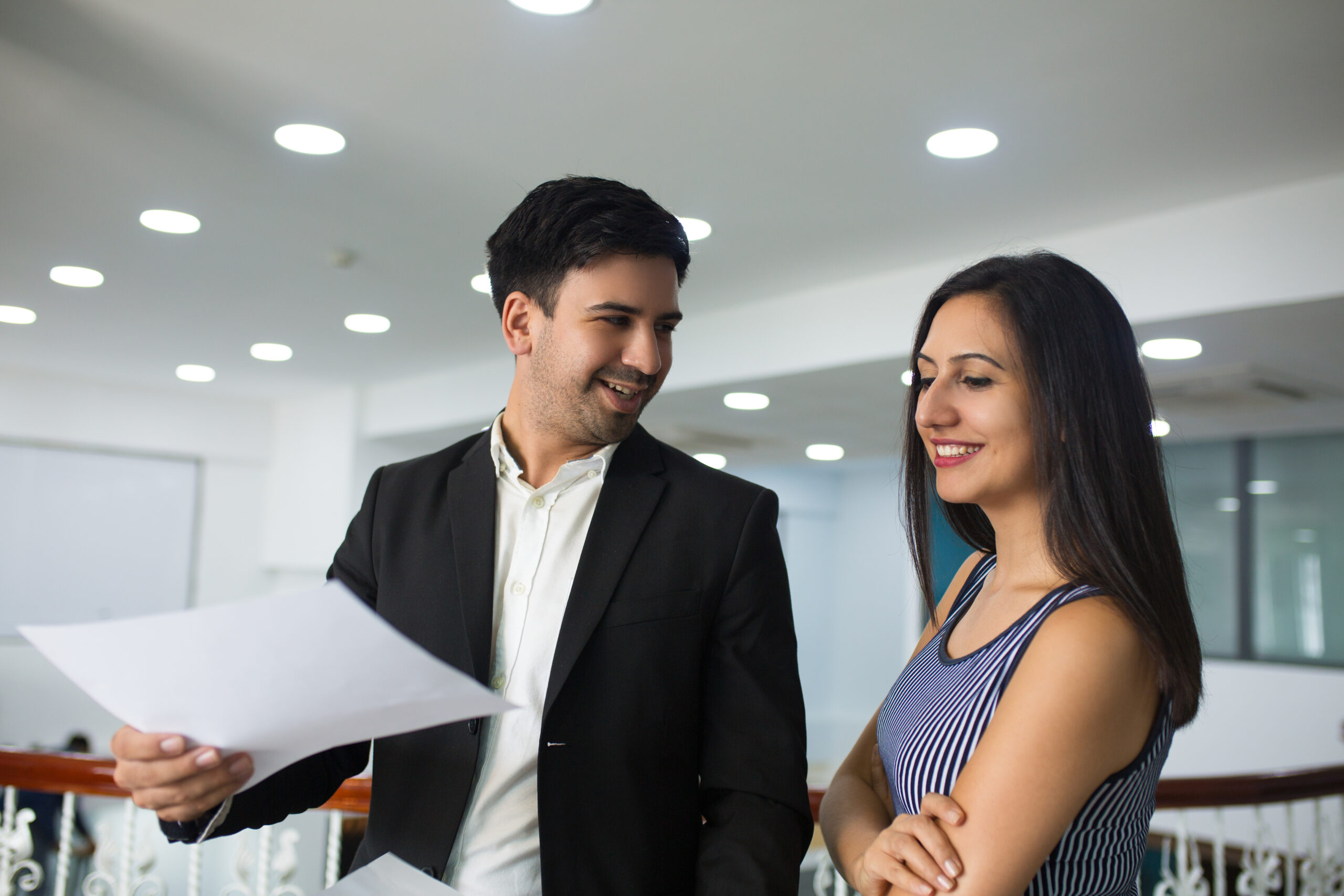 smiling handsome businessman showing annual report colleague scaled